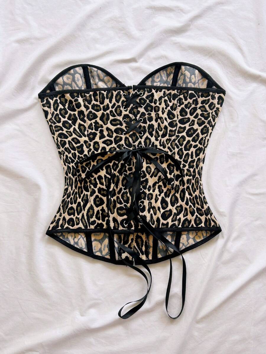 Strapless black lace-up corset top for women with grommet eyelet details, slim fit, lined body, and woven fabric construction.