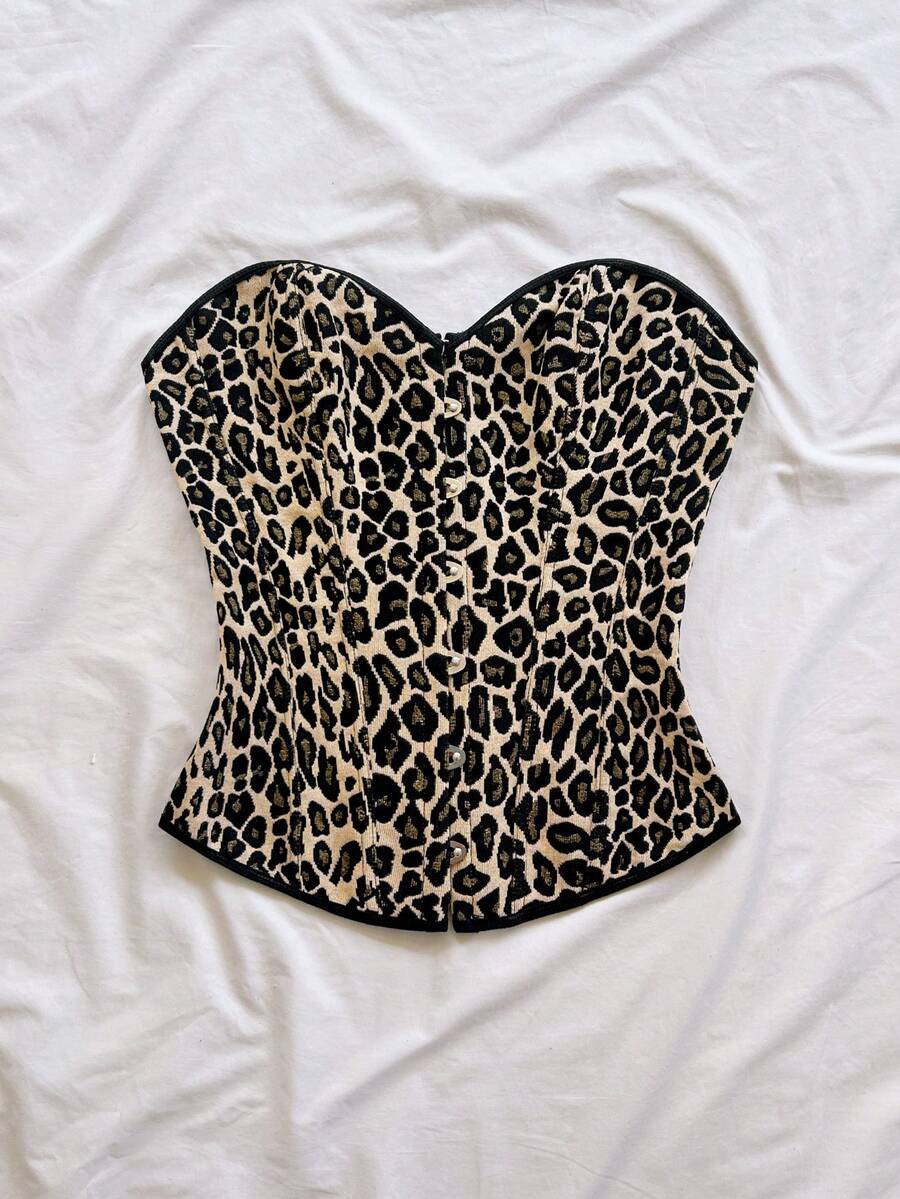 Strapless black lace-up corset top for women with grommet eyelet details, slim fit, lined body, and woven fabric construction.