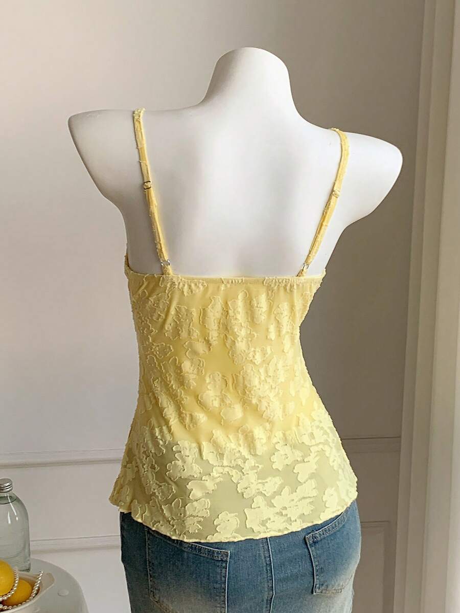 Black and white polka dot tie strap camisole top for women with thin spaghetti straps and slim fit.