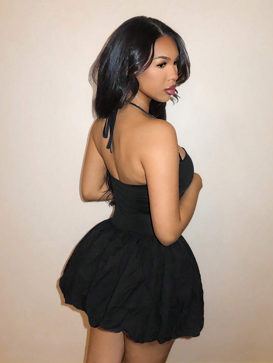 BamGlam women's black mini cami dress featuring a deep V-neckline with hollowed-out crisscross straps, spaghetti straps, and a flared hem.