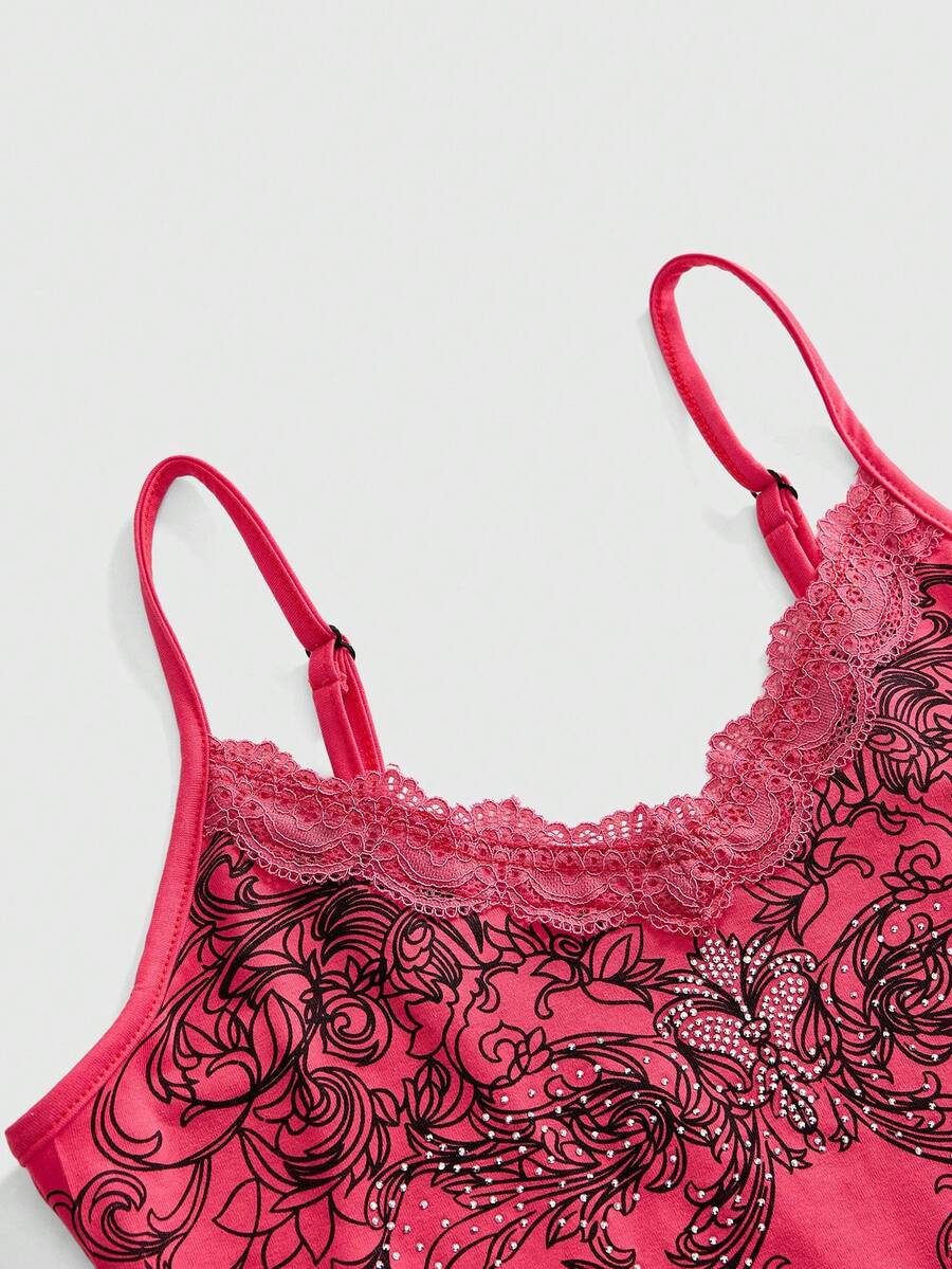 Pink floral print crop camisole top for women featuring contrast lace trim, spaghetti straps, and a slim fit.