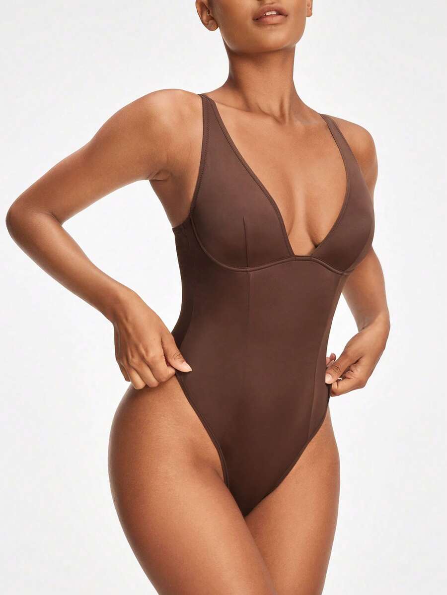 Apricot backless shapewear bodysuit with thong cut, cup details, and high-stretch fabric for light tummy support.