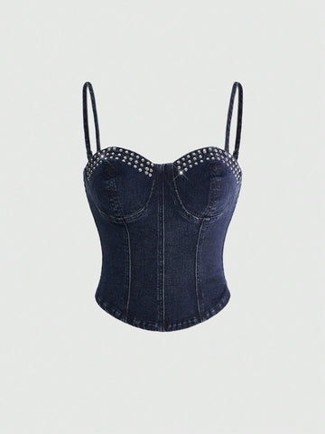 Dark wash denim camisole top for women with rhinestone embellishments, spaghetti straps, front zipper closure, and an asymmetrical micro crop hem.
