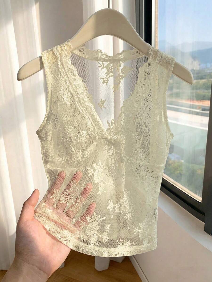 Franclia women's black semi-sheer lace camisole featuring a deep V-neckline with contrast lace trim in a slim fit sleeveless design.