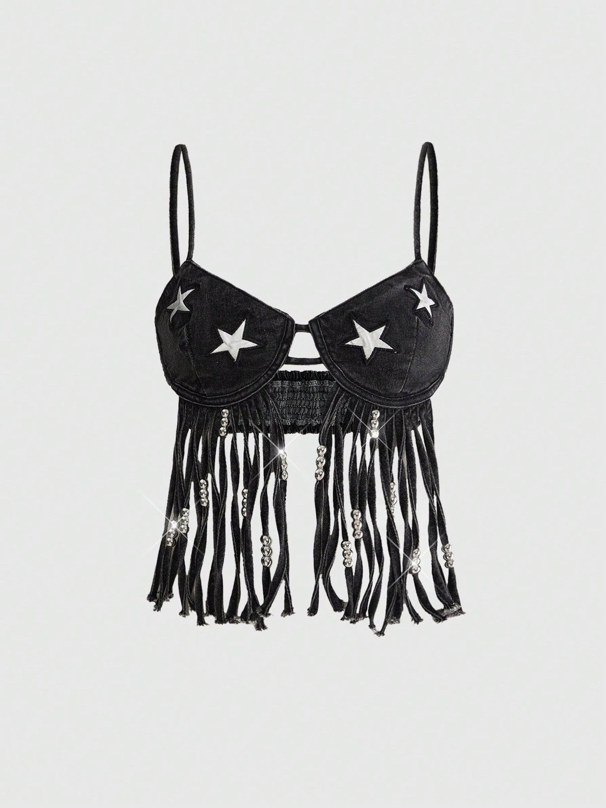Blue denim camisole top for women featuring star patch detailing, fringe tassel asymmetrical hem, and spaghetti straps.