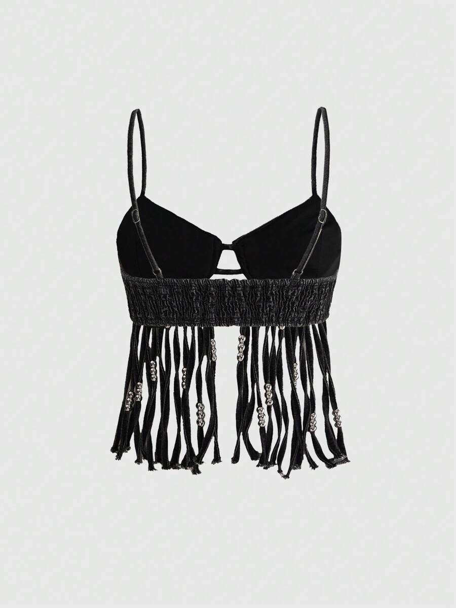 Blue denim camisole top for women featuring star patch detailing, fringe tassel asymmetrical hem, and spaghetti straps.