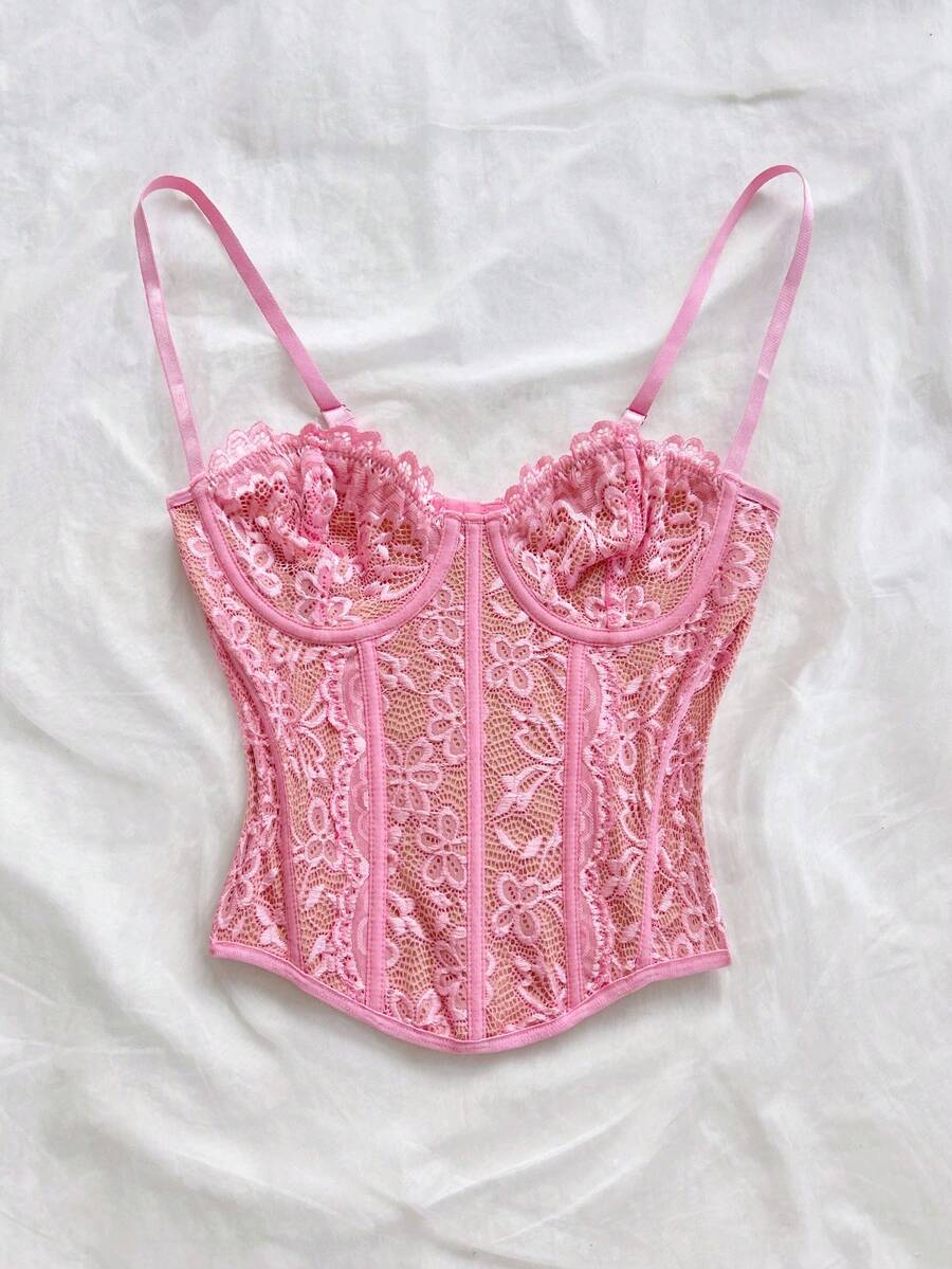 Women's lace bustier camisole top with spaghetti straps, contrast lace, lace-up detail, and an asymmetrical hem in a slim fit design.