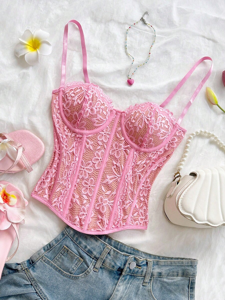 Women's lace bustier camisole top with spaghetti straps, contrast lace, lace-up detail, and an asymmetrical hem in a slim fit design.