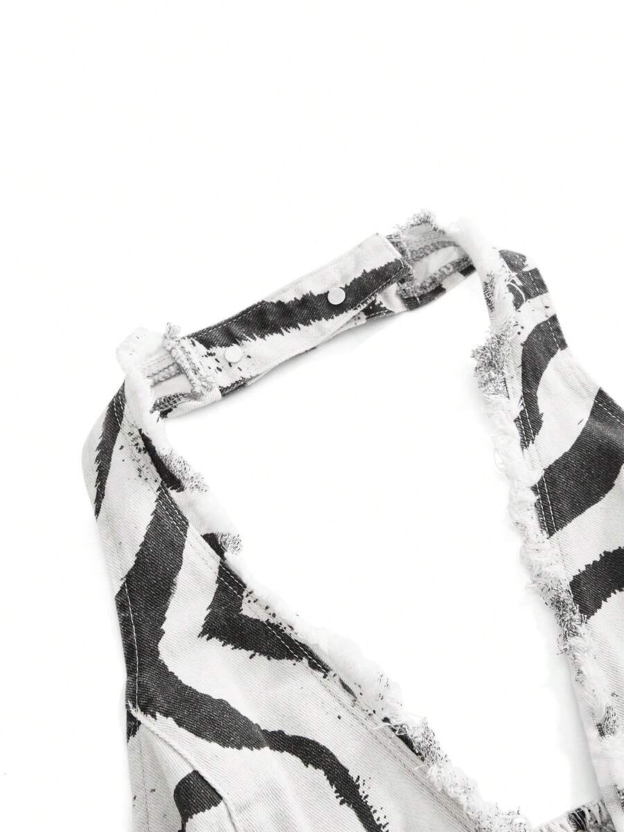 Women's denim halter crop top featuring a backless design, asymmetrical hem, single-breasted front, and lettuce trim.