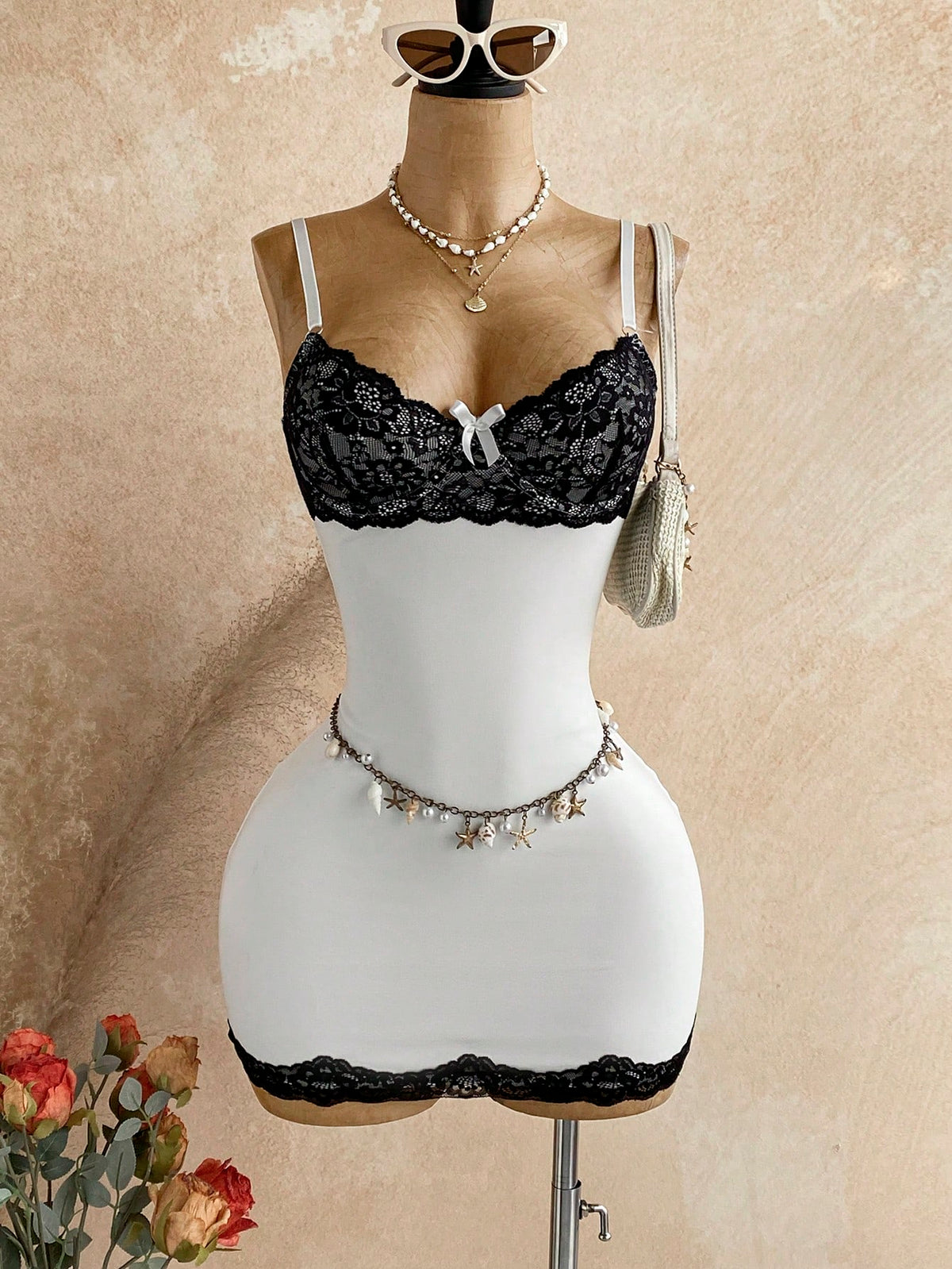 Women's black mesh bodycon mini dress featuring spaghetti straps, contrast lace cup details, backless styling, and a slim fit.