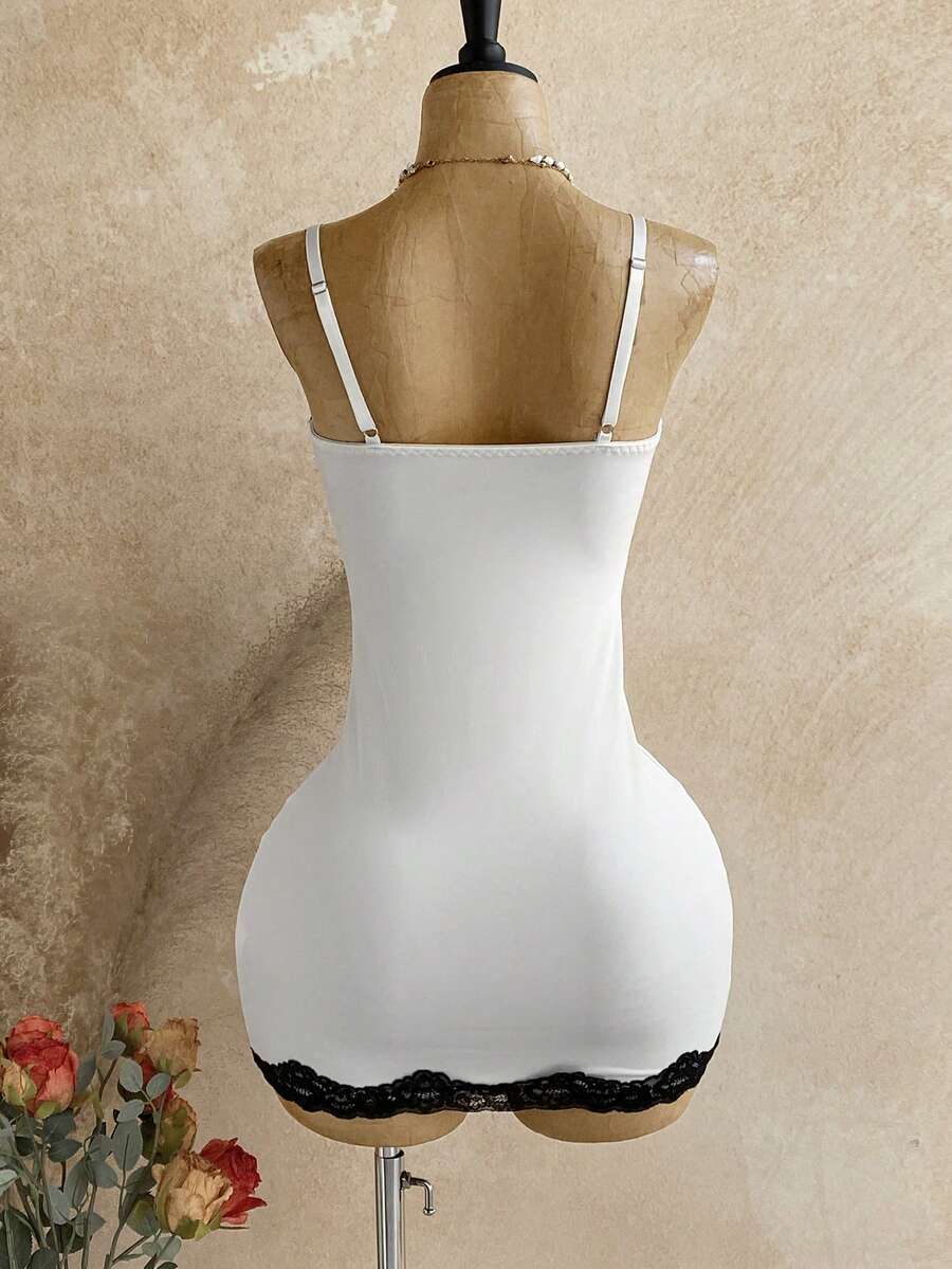 Women's black mesh bodycon mini dress featuring spaghetti straps, contrast lace cup details, backless styling, and a slim fit.