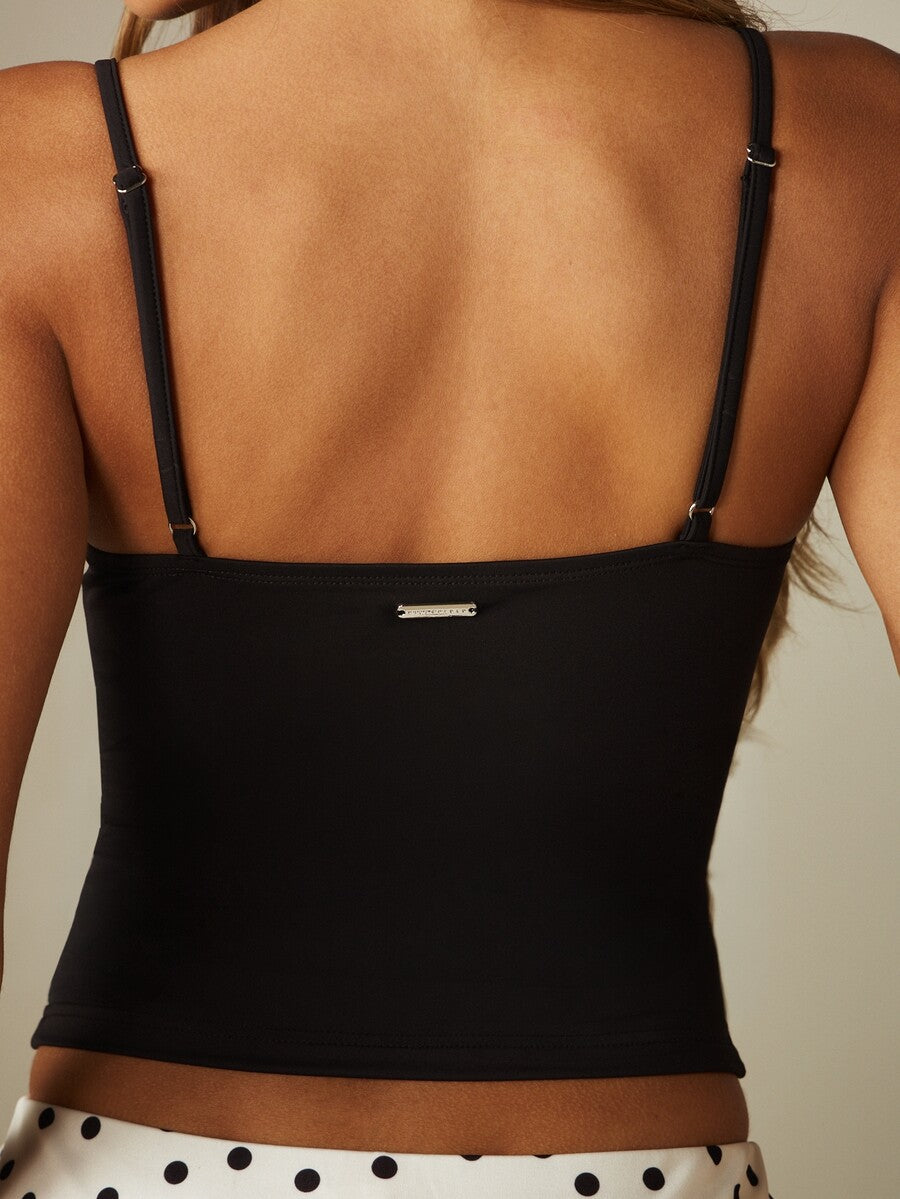 Women’s plain backless cami top with spaghetti straps and a slim fit, designed in high-stretch knitted fabric for casual beach and vacation wear.