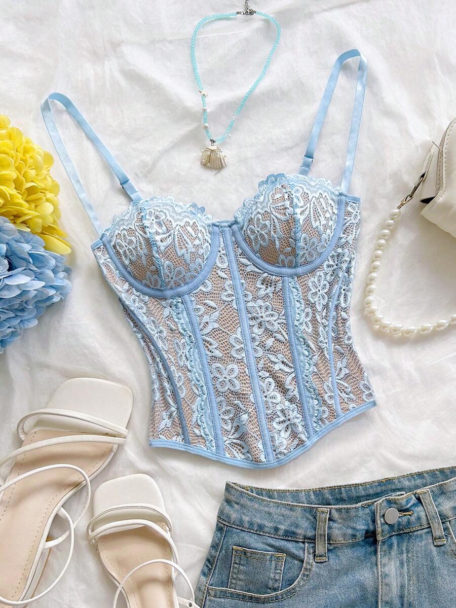 Women's lace bustier camisole top with spaghetti straps, contrast lace, lace-up detail, and an asymmetrical hem in a slim fit design.