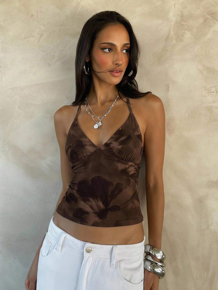 Women's black faux leather backless cami top with spaghetti straps and lace-up shirred sides.