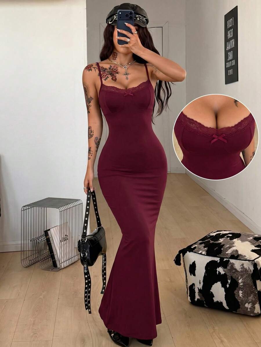 Black backless cami midi dress for women featuring spaghetti straps, slim fit mermaid silhouette, backless button detail, and high stretch knitted fabric.
