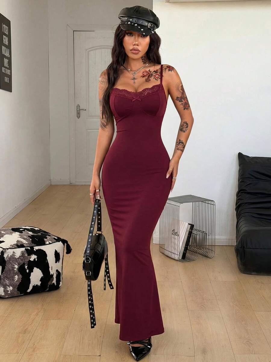 Black backless cami midi dress for women featuring spaghetti straps, slim fit mermaid silhouette, backless button detail, and high stretch knitted fabric.