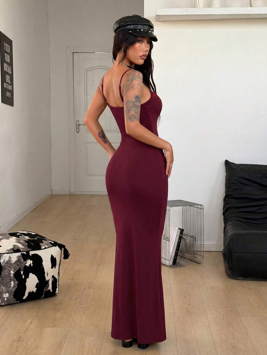 Black backless cami midi dress for women featuring spaghetti straps, slim fit mermaid silhouette, backless button detail, and high stretch knitted fabric.