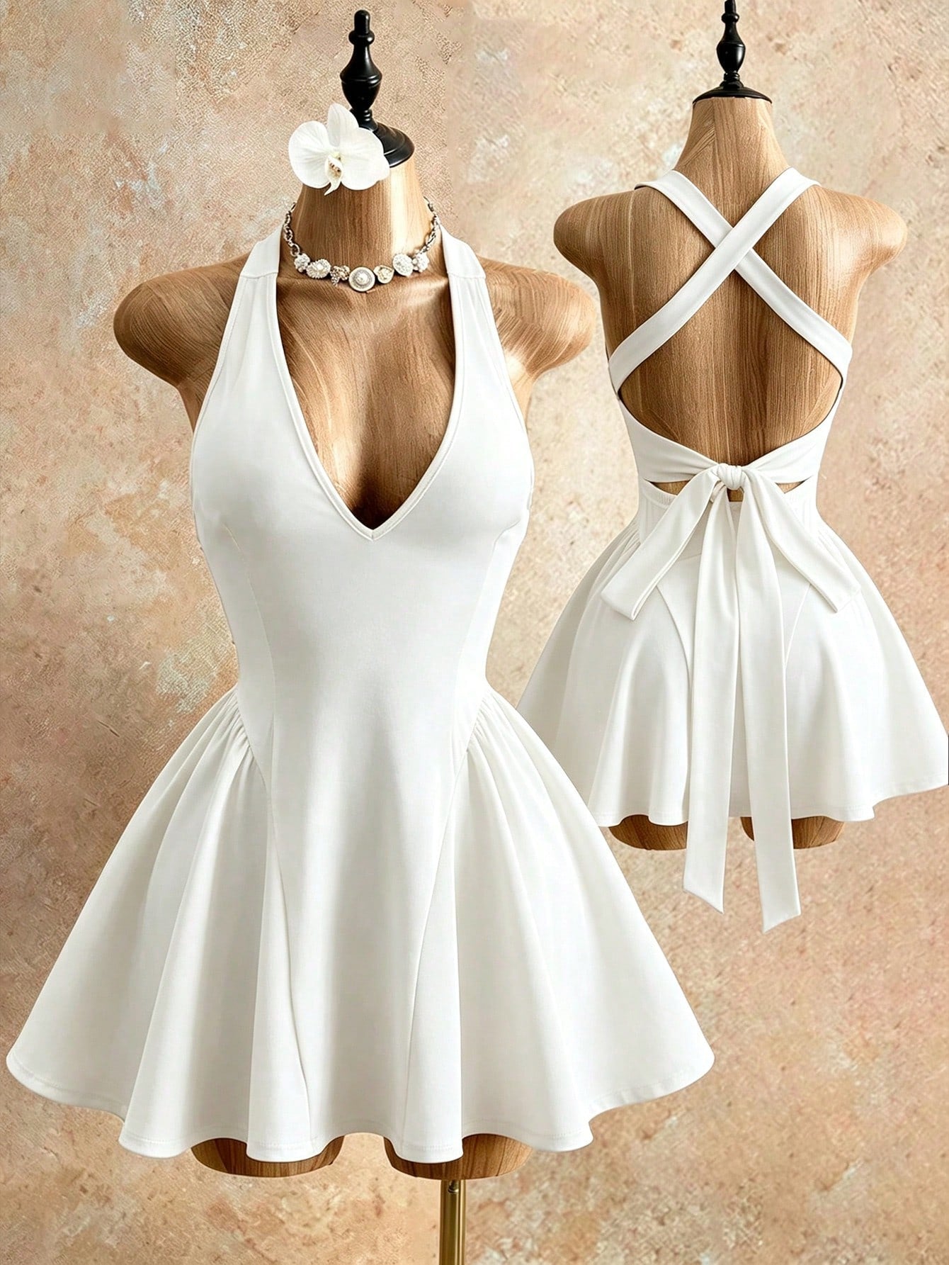 Sleeveless black halter mini dress for women featuring a high waist, A-line flared hem, and criss cross details.