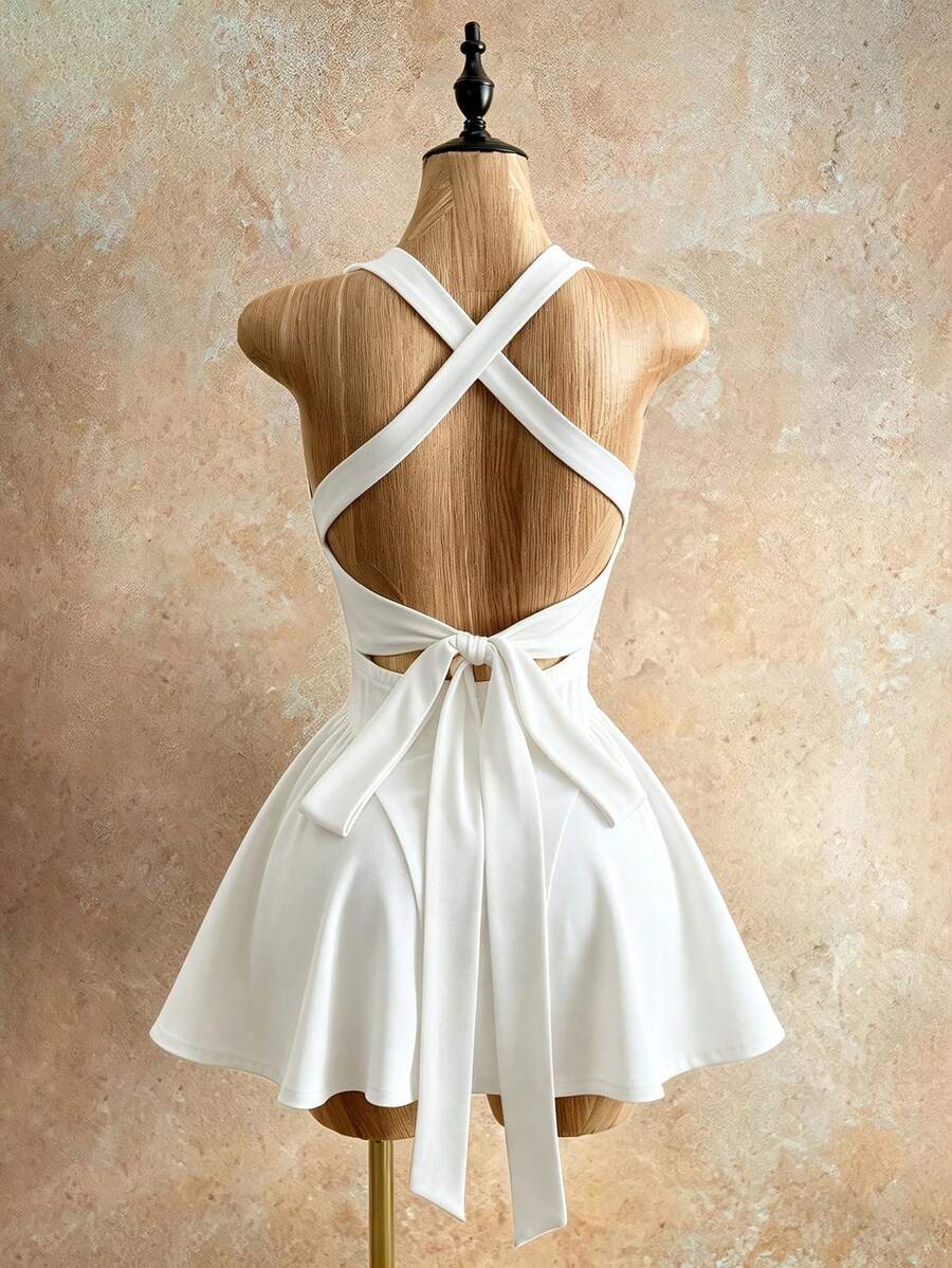 Sleeveless black halter mini dress for women featuring a high waist, A-line flared hem, and criss cross details.
