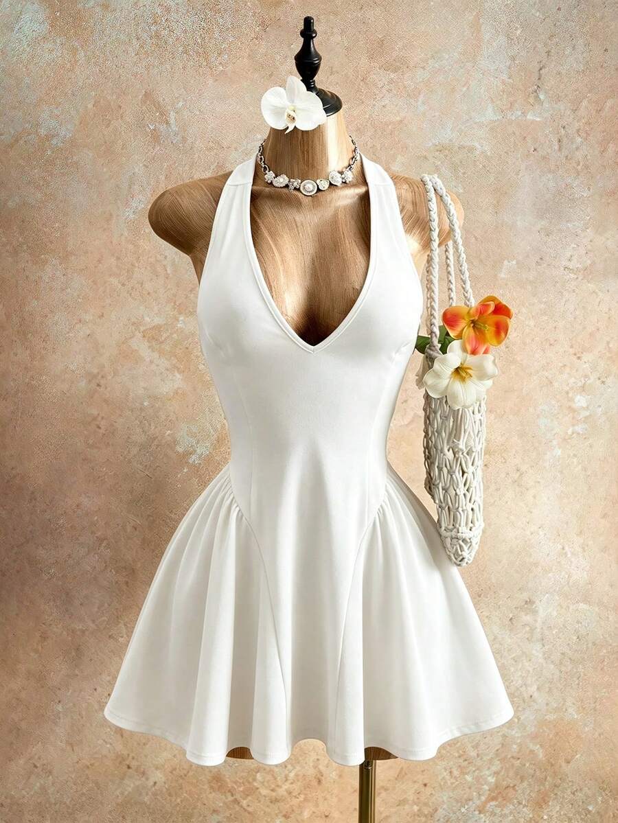 Sleeveless black halter mini dress for women featuring a high waist, A-line flared hem, and criss cross details.