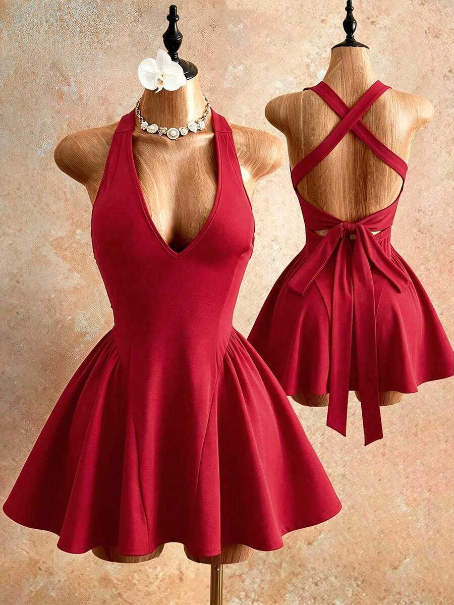 Sleeveless black halter mini dress for women featuring a high waist, A-line flared hem, and criss cross details.