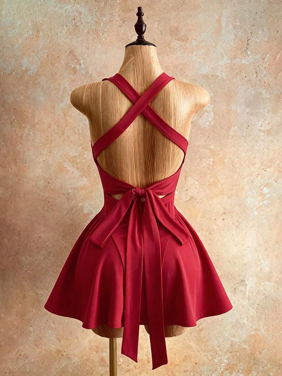 Sleeveless black halter mini dress for women featuring a high waist, A-line flared hem, and criss cross details.