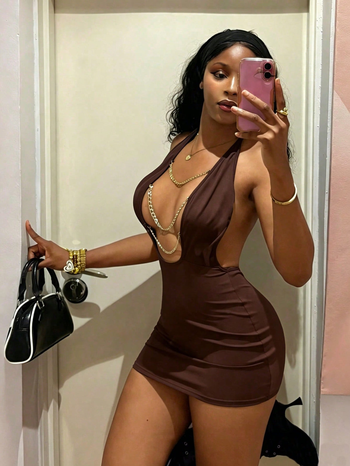 Women's black deep V-neck halter bodycon mini dress featuring a backless design with chain decor detail.