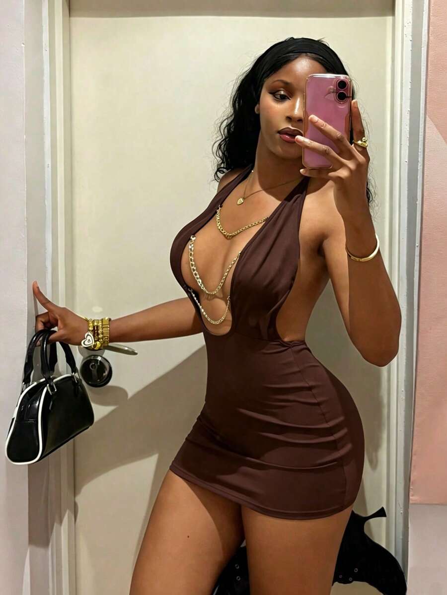 Women's black deep V-neck halter bodycon mini dress featuring a backless design with chain decor detail.