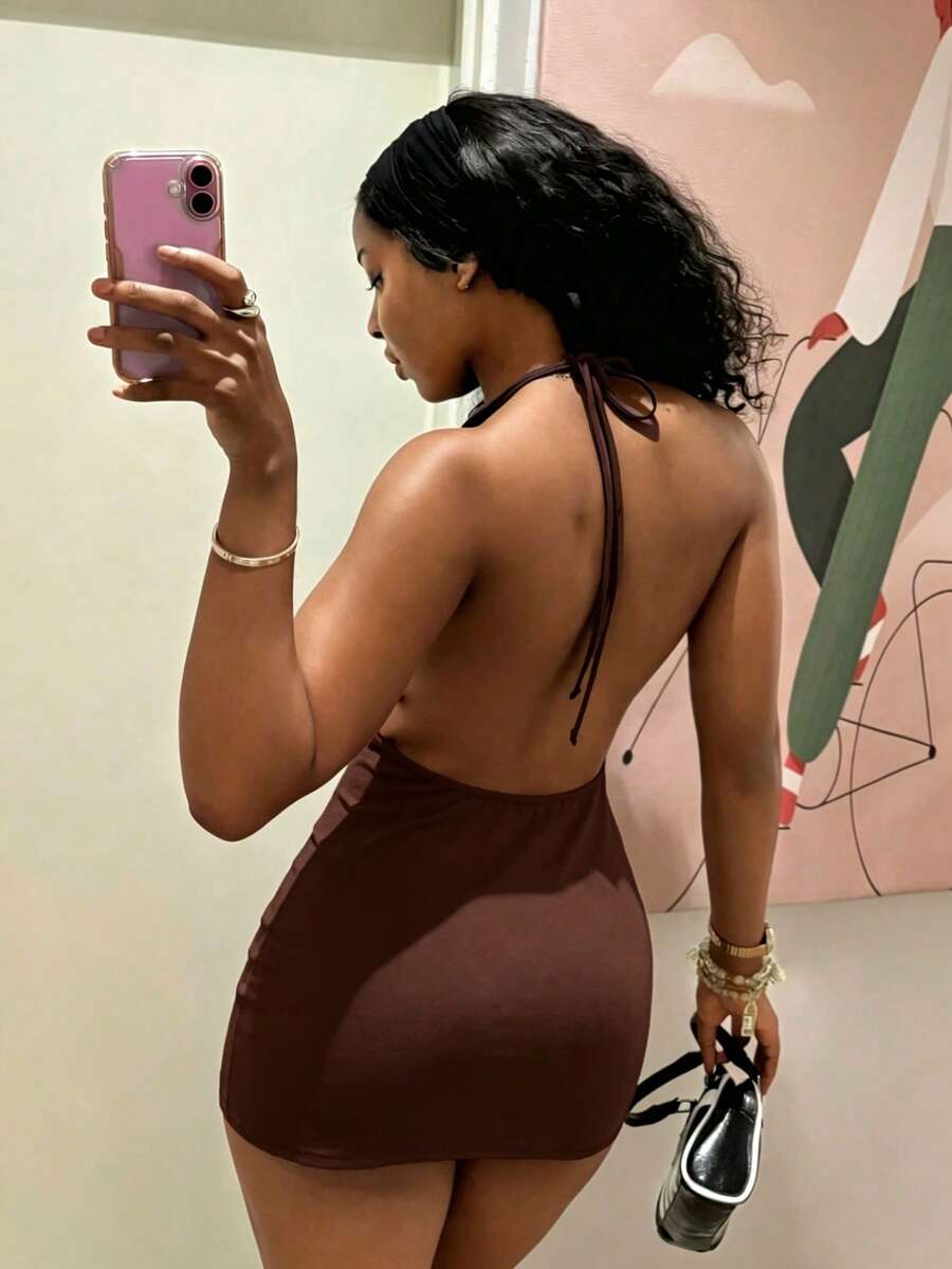 Women's black deep V-neck halter bodycon mini dress featuring a backless design with chain decor detail.