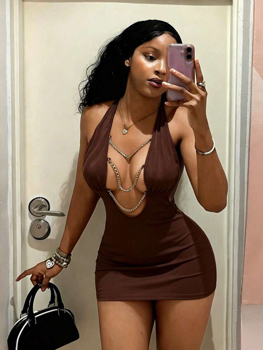 Women's black deep V-neck halter bodycon mini dress featuring a backless design with chain decor detail.