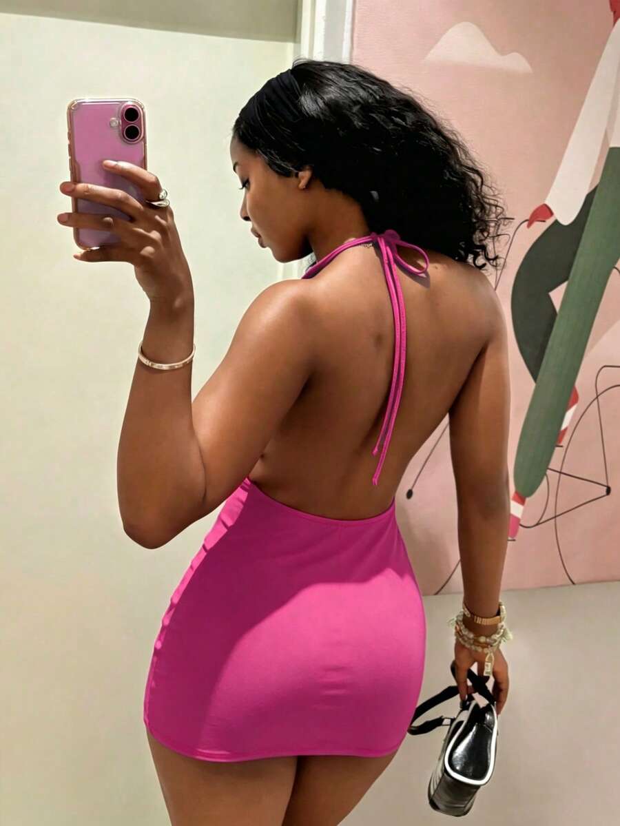 Women's black deep V-neck halter bodycon mini dress featuring a backless design with chain decor detail.