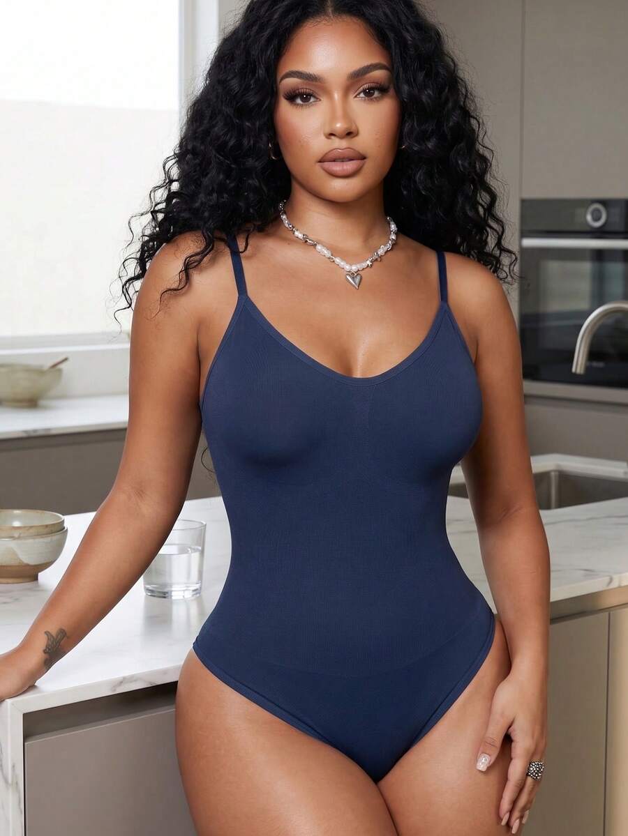 Brown seamless shapewear bodysuit featuring backless design, thong bottom, non-removable padding, and high-stretch fabric for tummy and waist control.
