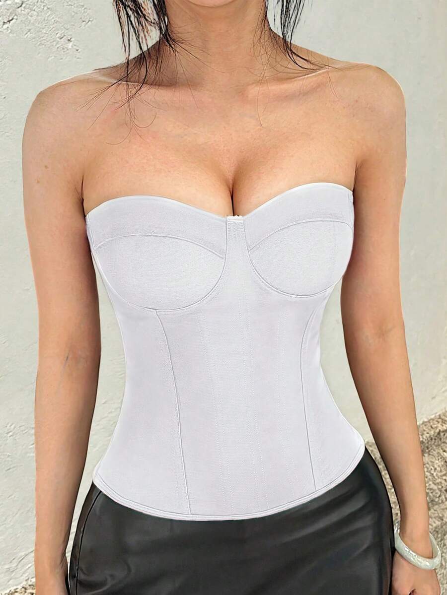Black strapless corset top with boning, lace-up back, and a cropped slim-fit silhouette for women.