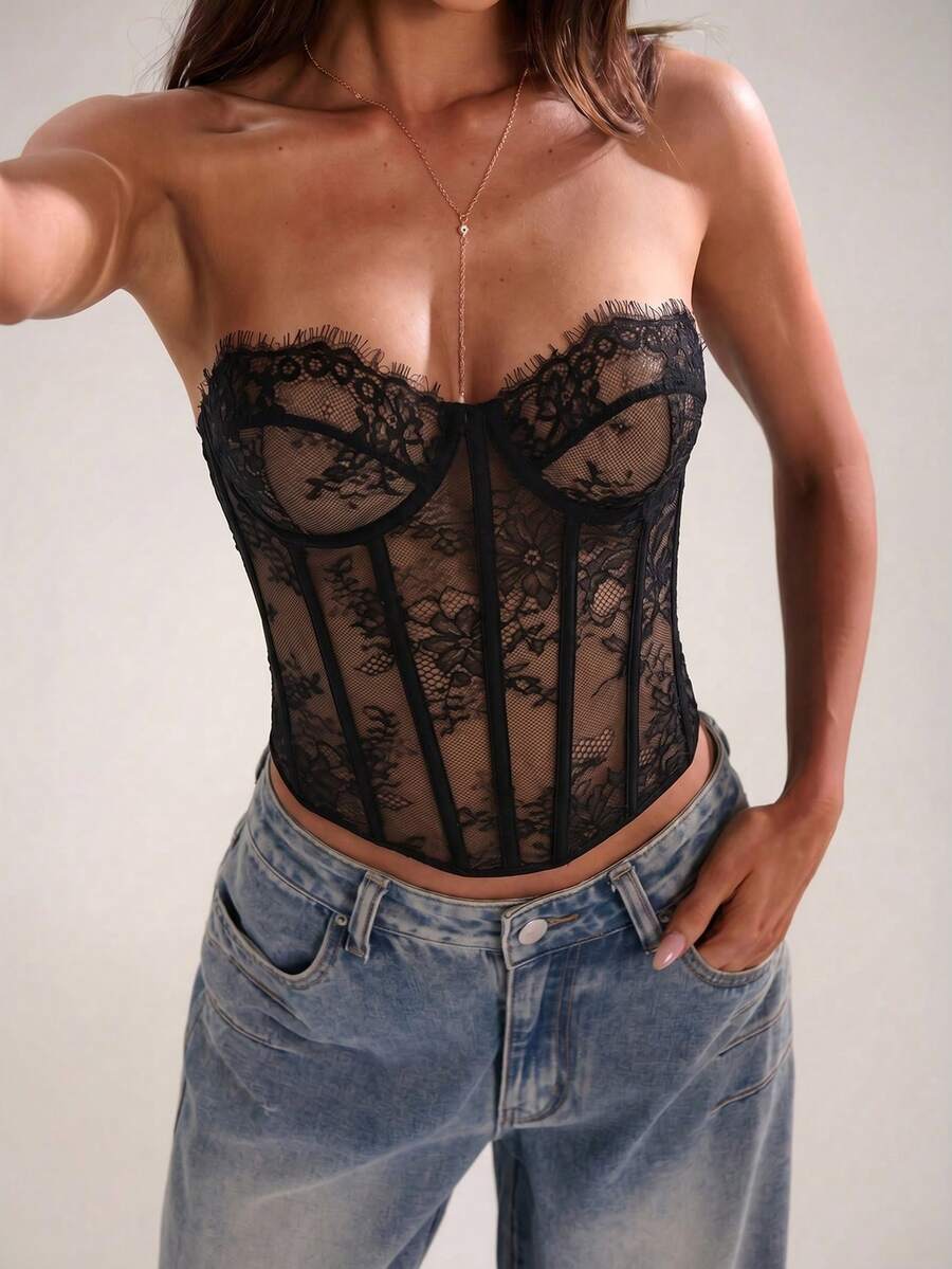 Women's strapless bustier crop top with contrast lace, lace-up detail, and an asymmetric hem in a slim-fit satin finish.