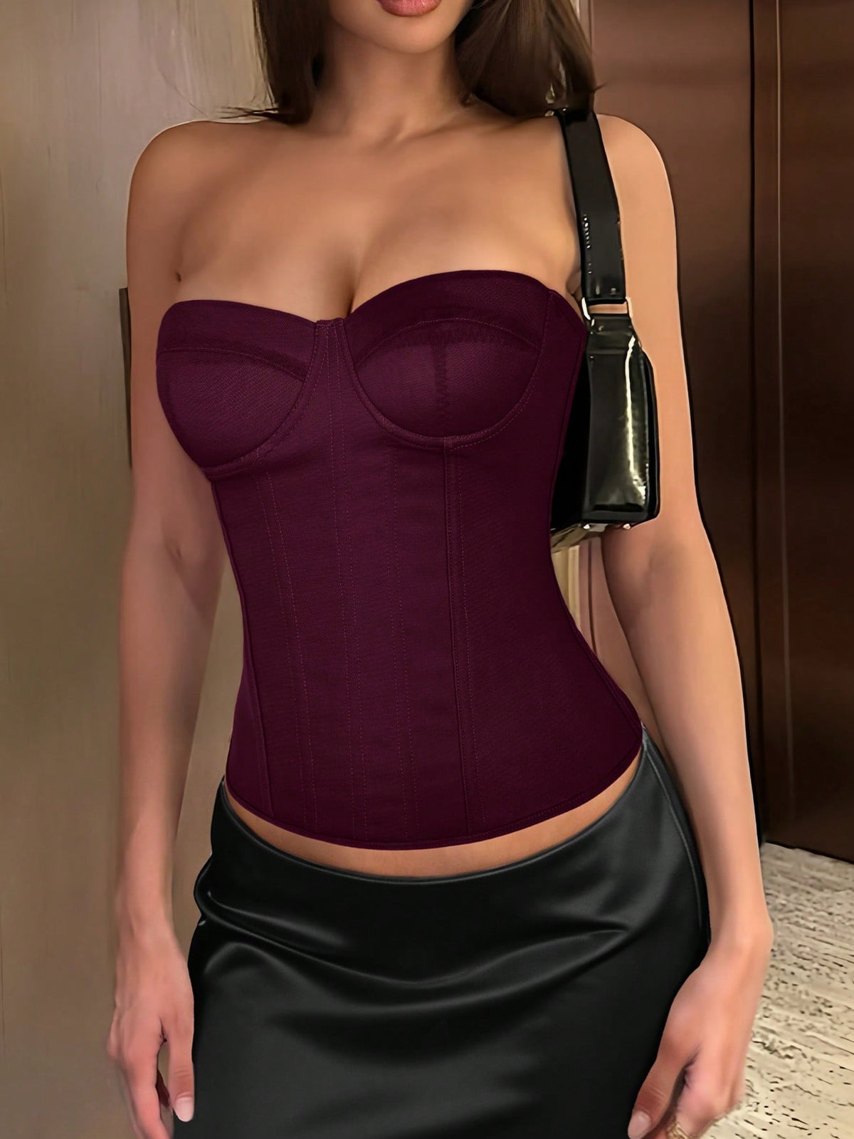 Black strapless corset top with boning, lace-up back, and a cropped slim-fit silhouette for women.