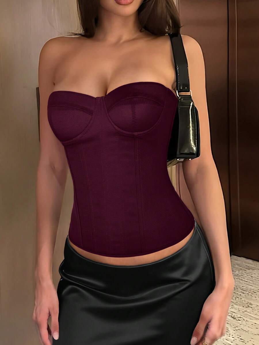 Black strapless corset top with boning, lace-up back, and a cropped slim-fit silhouette for women.