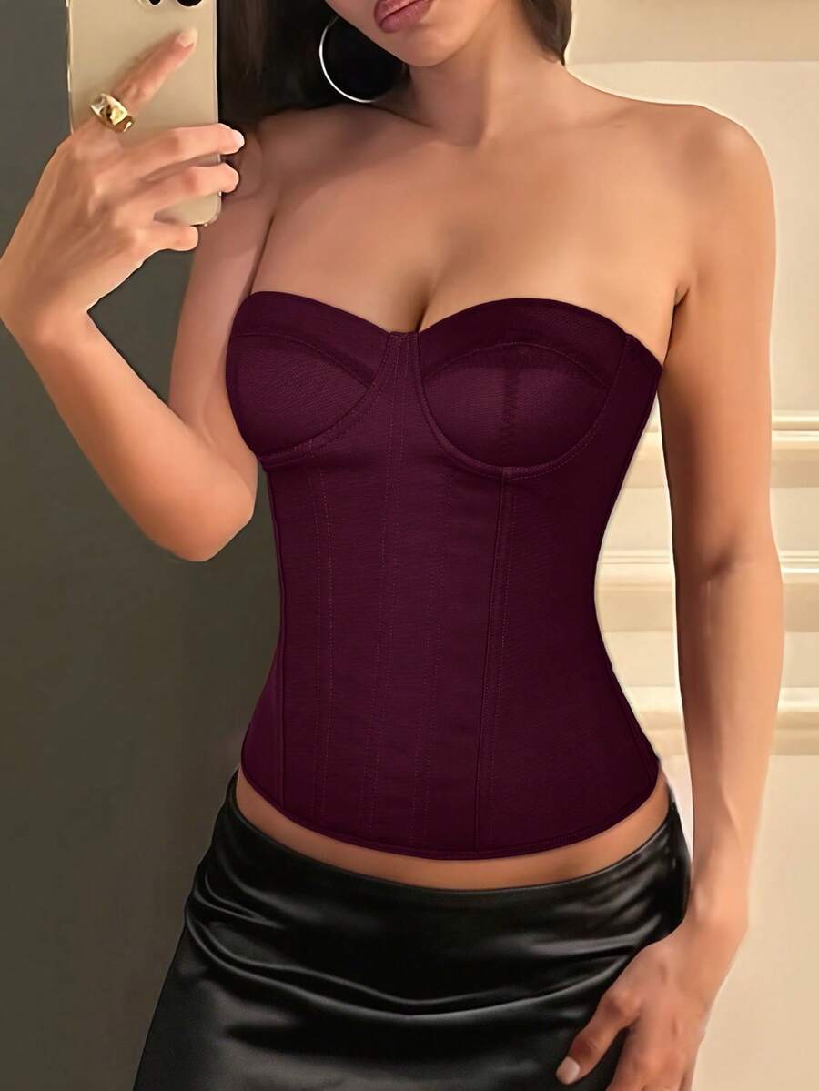 Black strapless corset top with boning, lace-up back, and a cropped slim-fit silhouette for women.
