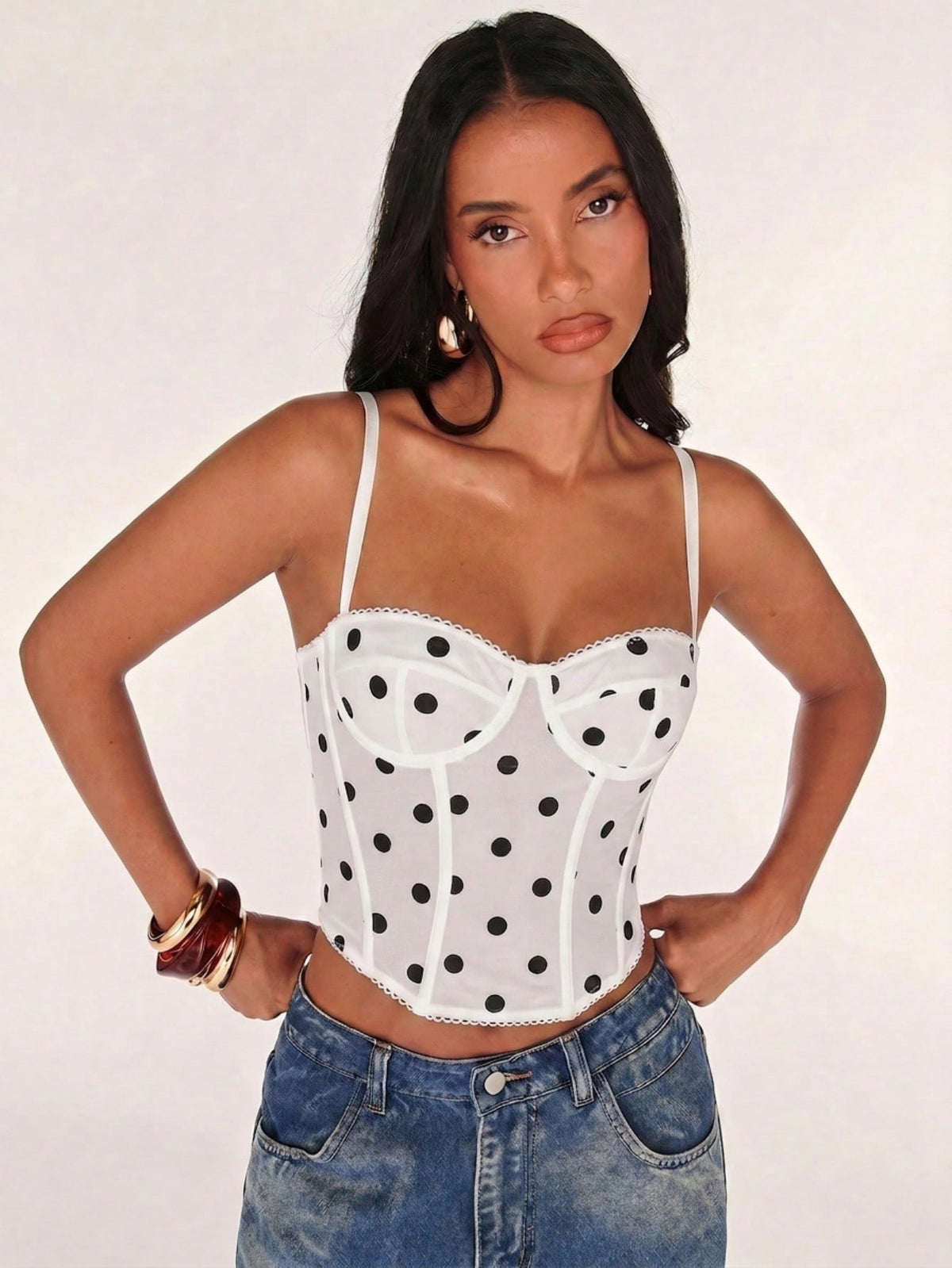 Black women’s lace cami top with spaghetti straps, contrast lace details, and an asymmetrical hem, styled as a slim-fit lined casual top.