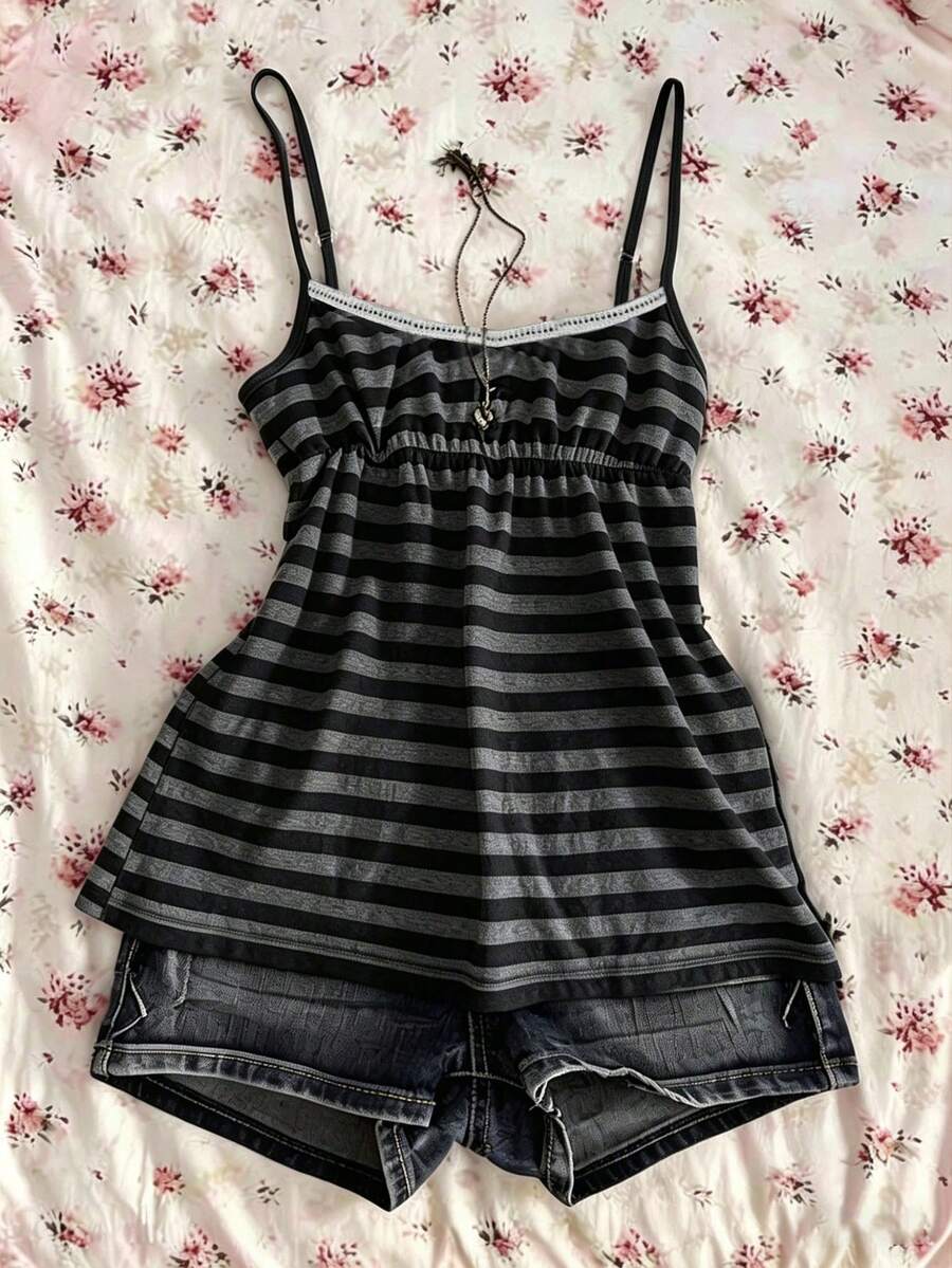 A women's black striped camisole top featuring spaghetti straps, a backless design with ring detail, and high-stretch knitted fabric.