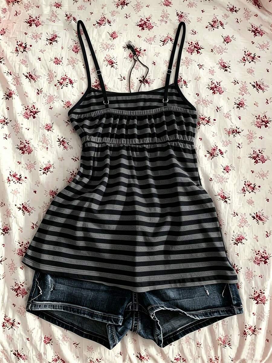 A women's black striped camisole top featuring spaghetti straps, a backless design with ring detail, and high-stretch knitted fabric.
