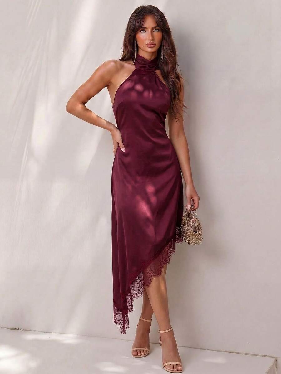 Black halter neck mini dress for women featuring a backless design with a large bow detail and an asymmetric contrast lace hem.