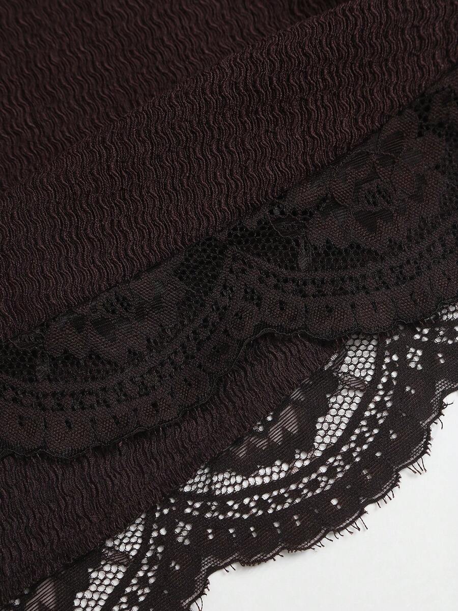 Women's black strapless lace patchwork bodycon mini dress featuring a slim fit design and an asymmetrical hem.