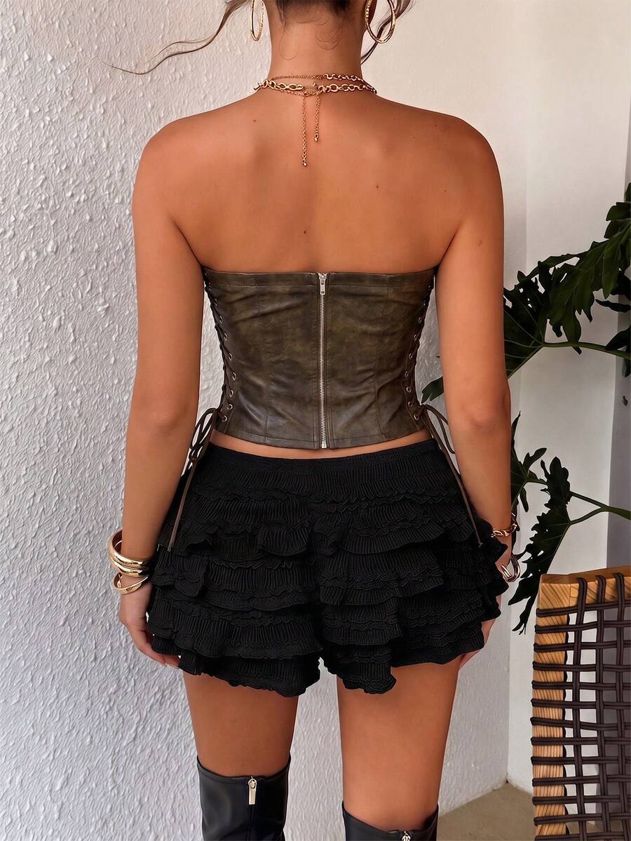 Women’s coffee brown faux leather lace-up crop top with strapless neckline, slit hem, and slim fitted silhouette for festival and nightlife wear.