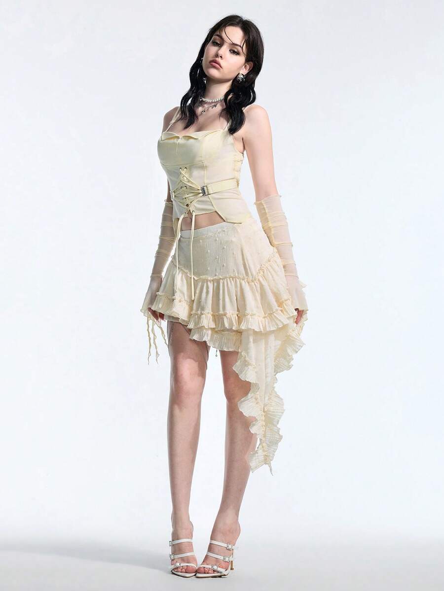 White lace-up crop camisole top for women featuring grommet eyelet details, a sweetheart neckline, shirred back, and asymmetrical hem.