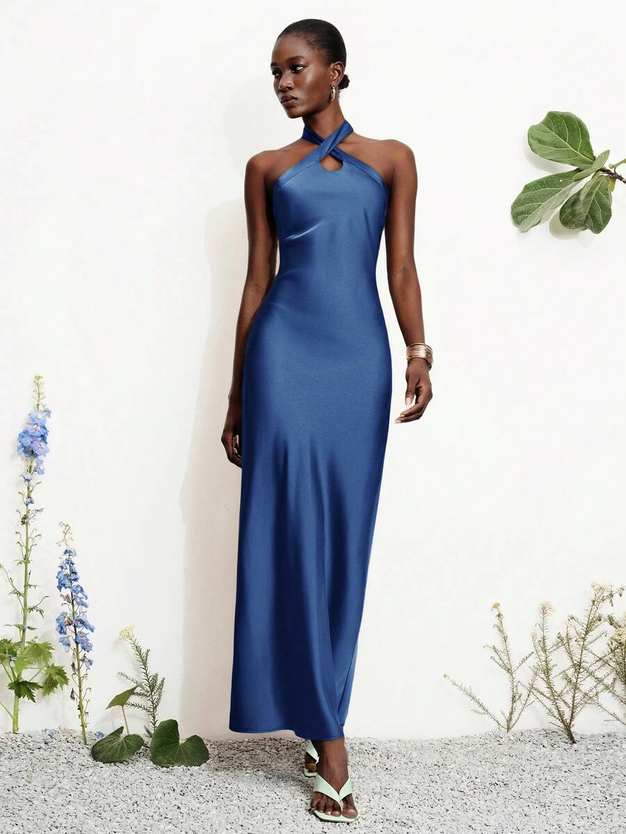 Women's black satin halter neck bodycon midi dress featuring a sleeveless backless design with front slit hem and wrap details.