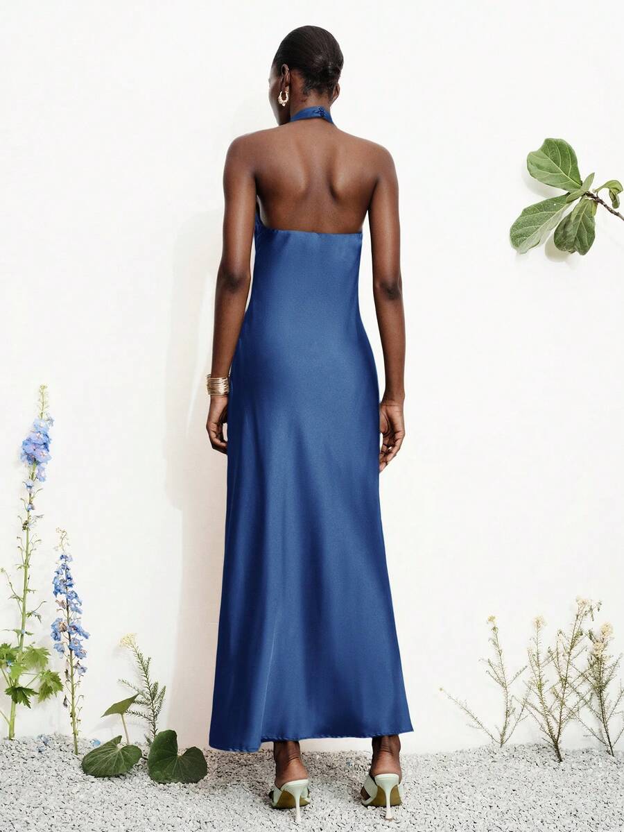 Women's black satin halter neck bodycon midi dress featuring a sleeveless backless design with front slit hem and wrap details.