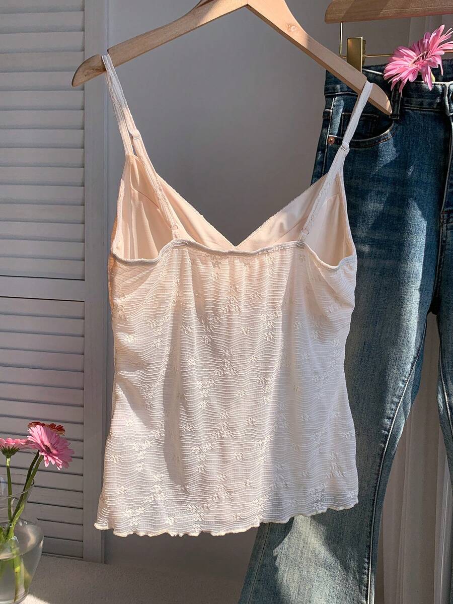 Black and white polka dot tie strap camisole top for women with thin spaghetti straps and slim fit.