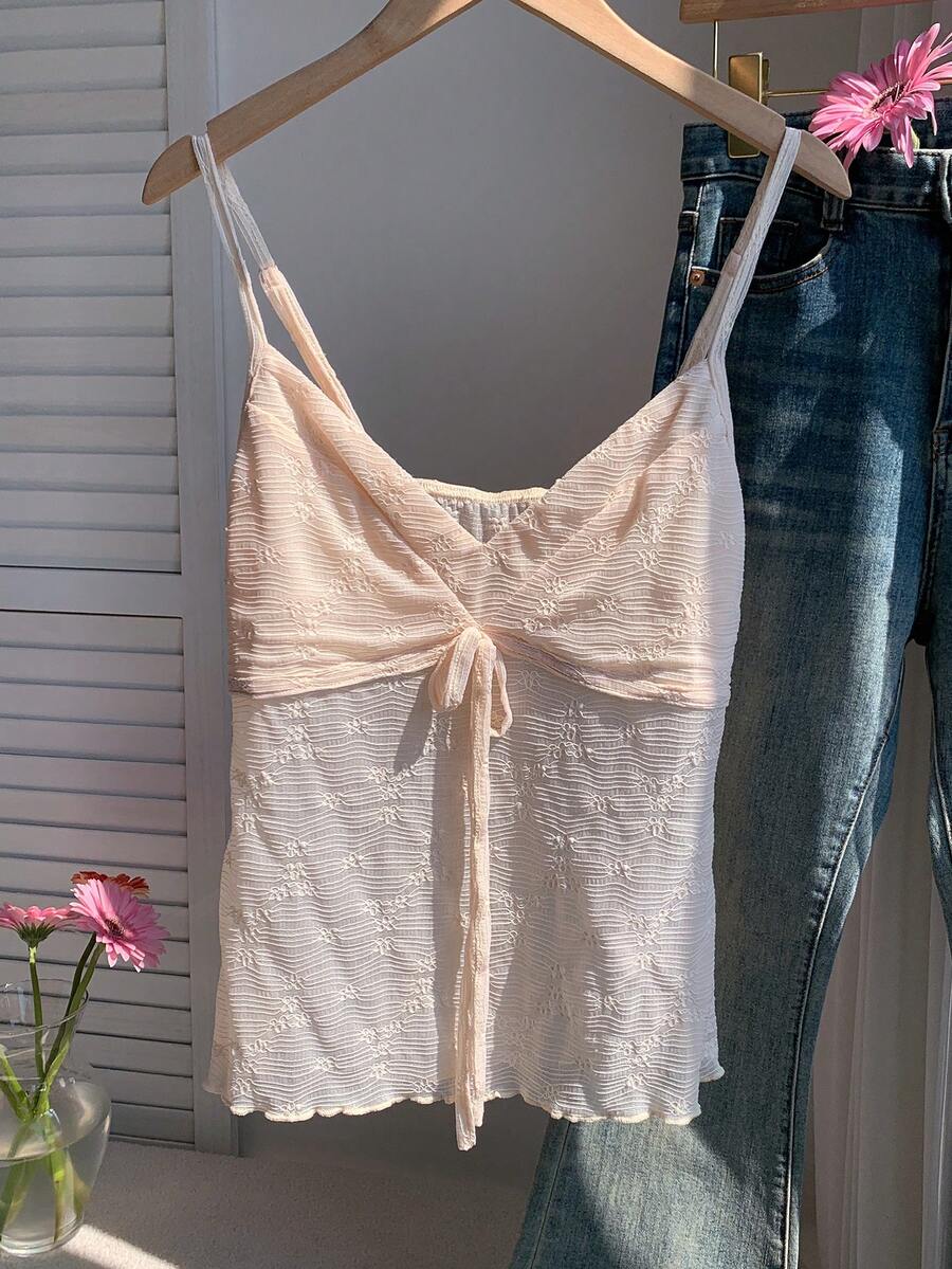 Black and white polka dot tie strap camisole top for women with thin spaghetti straps and slim fit.