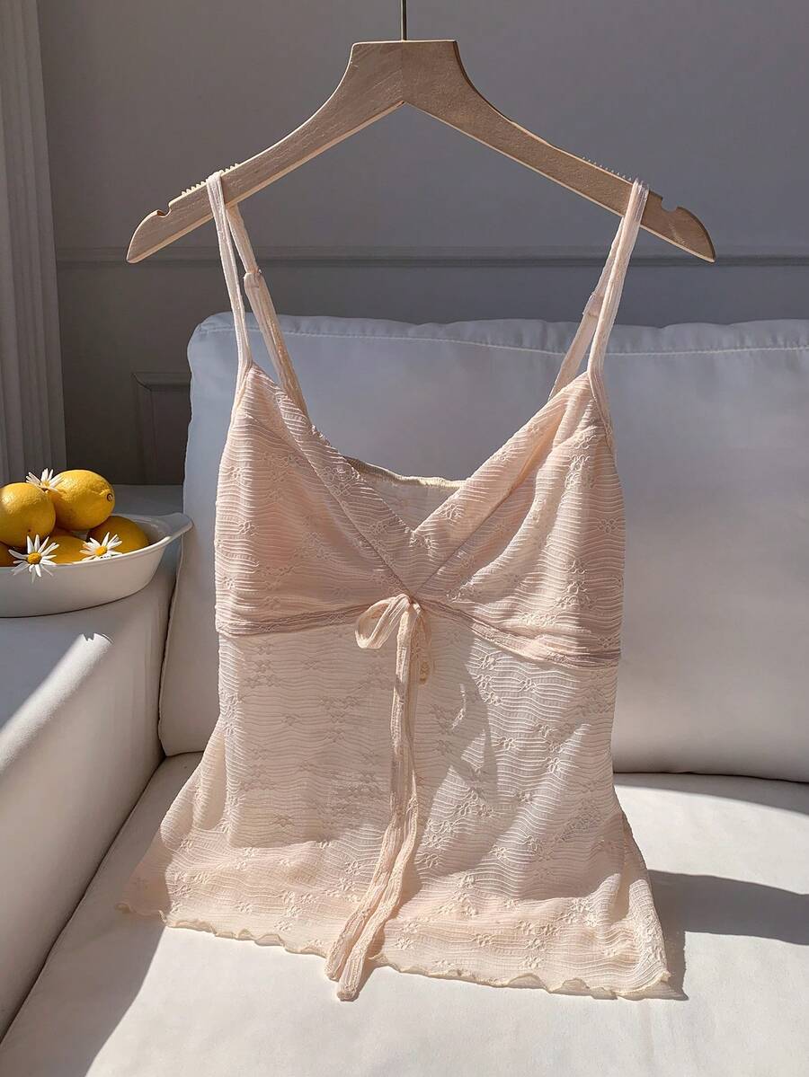 Black and white polka dot tie strap camisole top for women with thin spaghetti straps and slim fit.