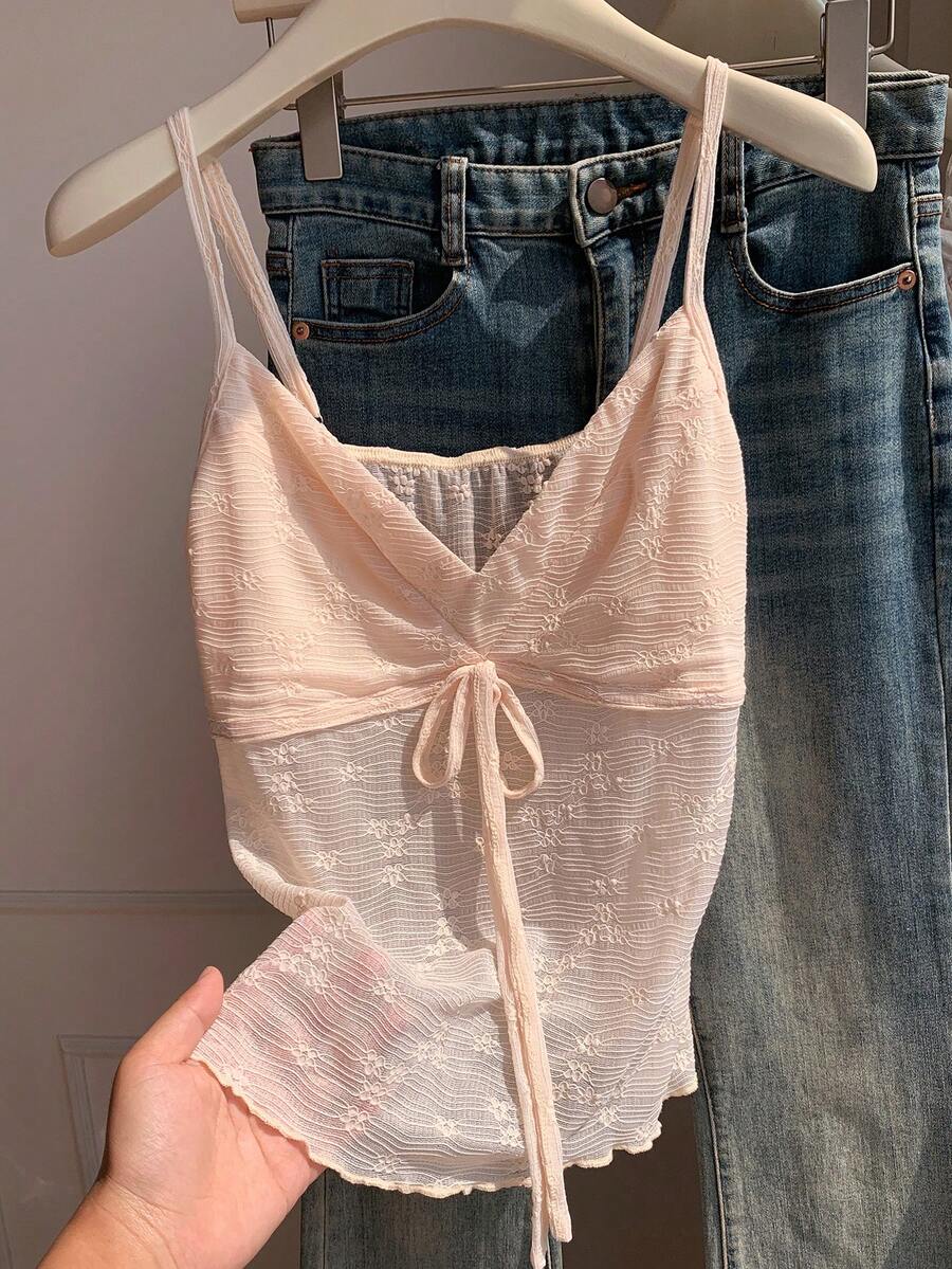 Black and white polka dot tie strap camisole top for women with thin spaghetti straps and slim fit.